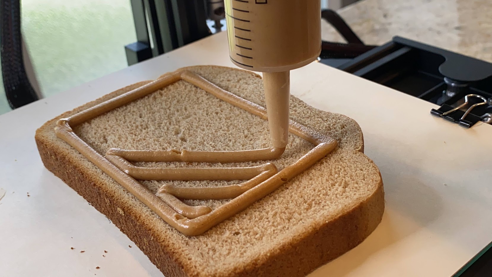 Extruding peanut butter from the syringe